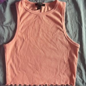 This is a cropped coral tank top